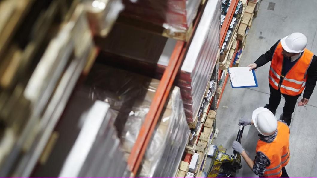Warehouse team checking pallet racking inventory