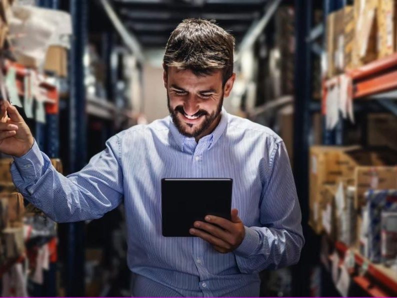 Warehouse manager checking inventory on a tablet